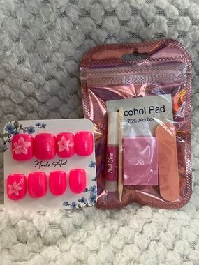 20 handmade Press-On nails using pink, white, and some glitter top coat!